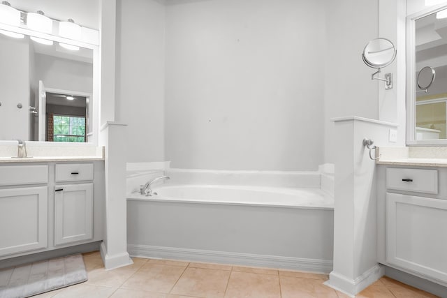 bathroom featuring vanity, a bath, and tile patterned floors