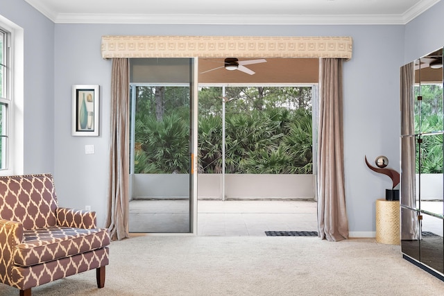 sitting room with crown molding, ceiling fan, and carpet floors