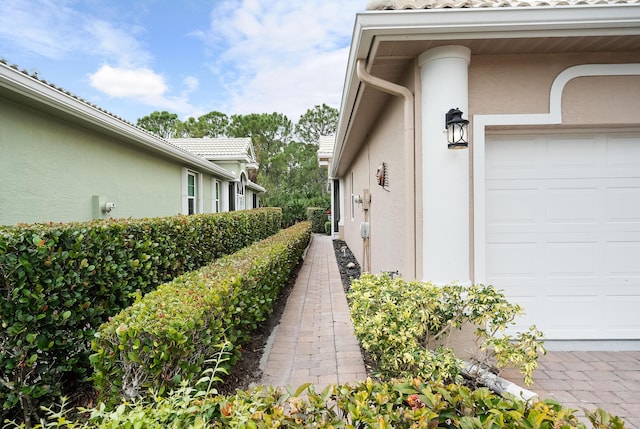 view of side of home featuring a garage