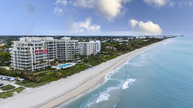 birds eye view of property with a beach view and a water view