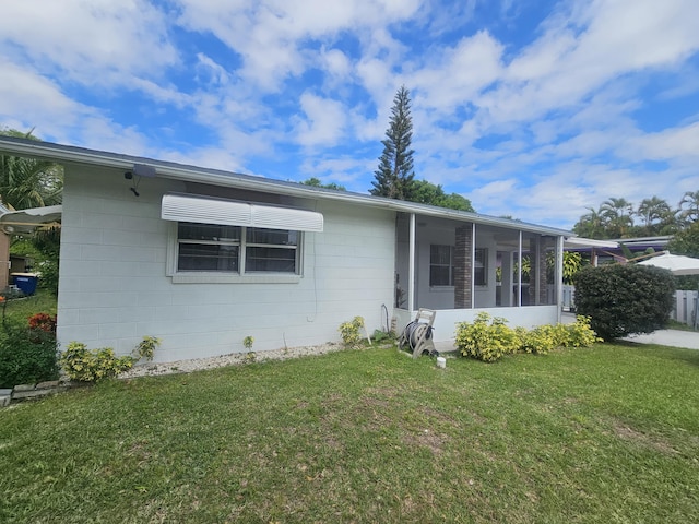 view of front facade with a front lawn and a sunroom