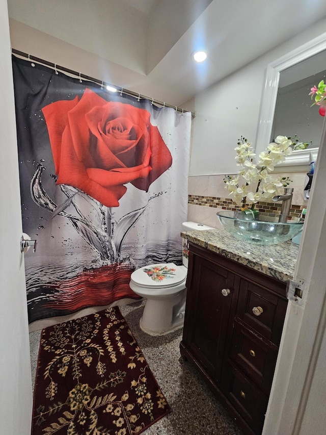 1105 Sunrise Blvd, Fort Pierce, FL 34950 - full bathroom with toilet, tile walls, wainscoting, curtained shower, and vanity