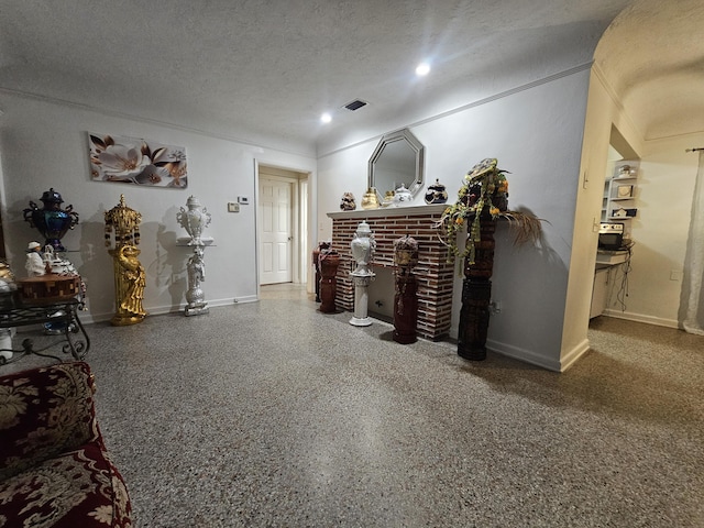 1105 Sunrise Blvd, Fort Pierce, FL 34950 - living room with a textured ceiling, speckled floor, a fireplace, baseboards, and visible vents