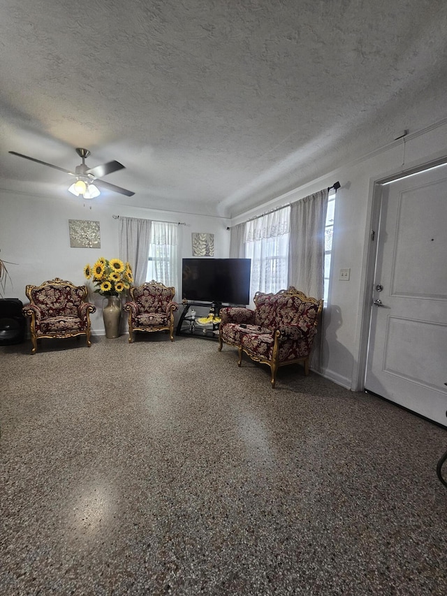 1105 Sunrise Blvd, Fort Pierce, FL 34950 - living room featuring speckled floor, a textured ceiling, and a ceiling fan