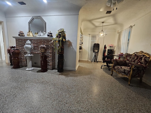 1105 Sunrise Blvd, Fort Pierce, FL 34950 - living area featuring speckled floor, visible vents, ceiling fan, and a fireplace