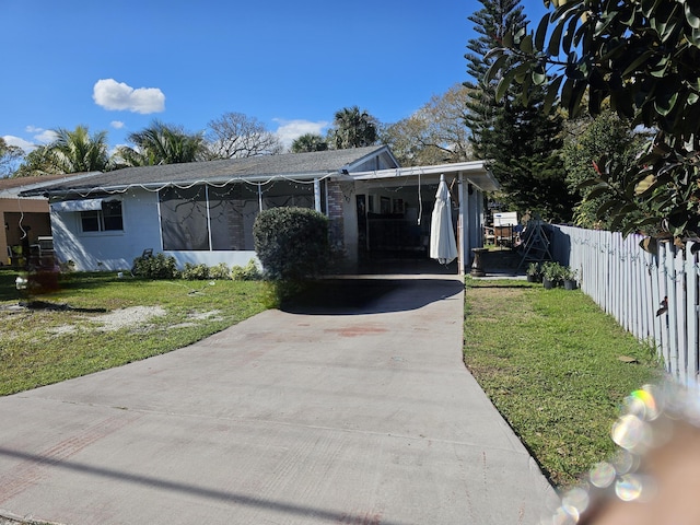 view of front of property with a carport and a front yard