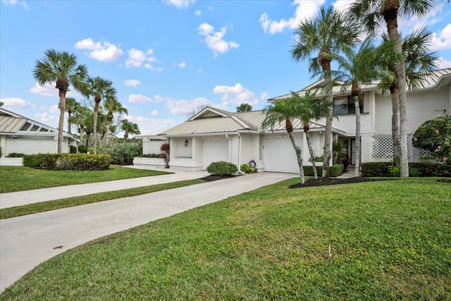 view of front of home with a garage and a front lawn