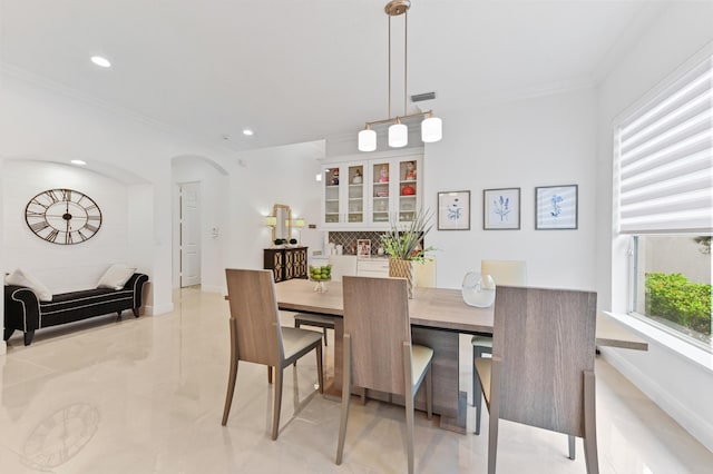 dining space featuring ornamental molding