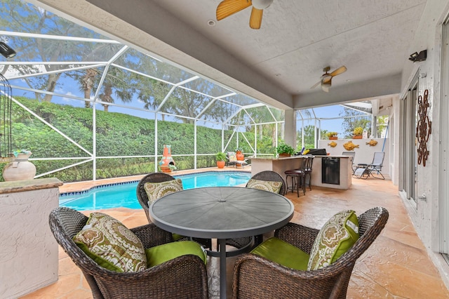 exterior space featuring exterior bar, a patio area, ceiling fan, and a lanai