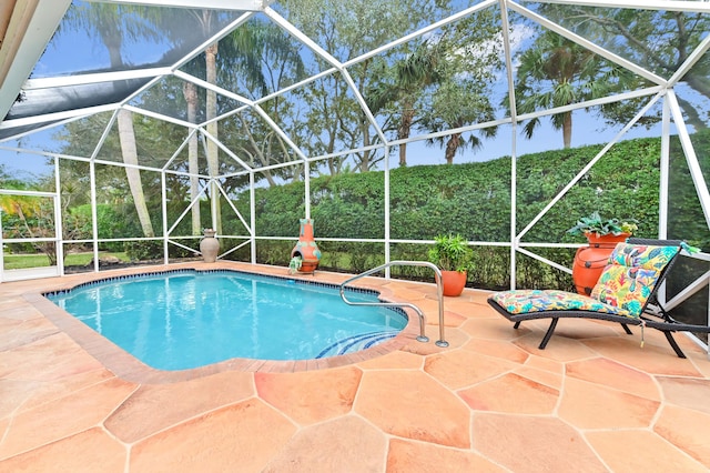 view of swimming pool featuring a patio area and glass enclosure