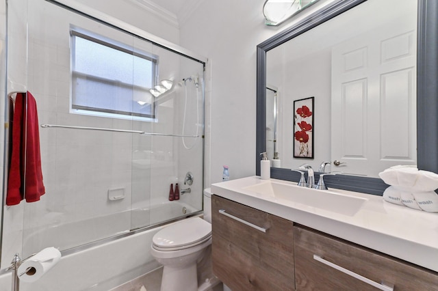 full bathroom featuring crown molding, vanity, toilet, and combined bath / shower with glass door