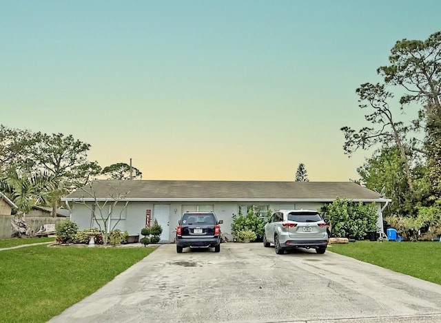 single story home with a yard and a garage