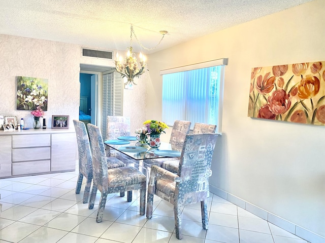 tiled dining space featuring a textured ceiling and a notable chandelier