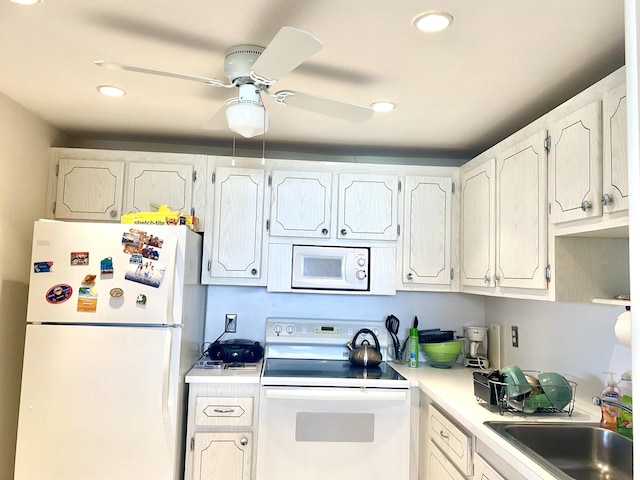 kitchen with ceiling fan, sink, white cabinets, and white appliances