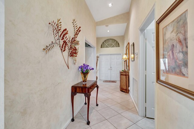 tiled dining space featuring lofted ceiling and a chandelier