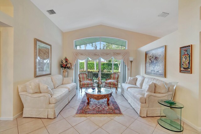 living room with lofted ceiling and light tile patterned floors