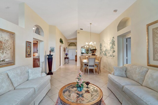 tiled dining room featuring a notable chandelier and a towering ceiling