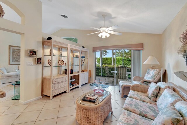 living room featuring ceiling fan, lofted ceiling, and light tile patterned floors