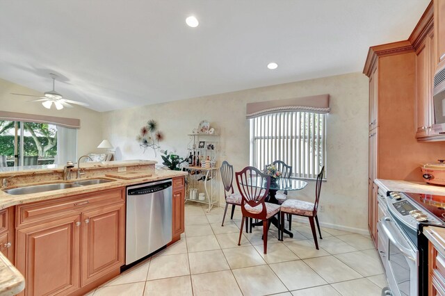 kitchen featuring tasteful backsplash, appliances with stainless steel finishes, light stone counters, and light tile patterned floors