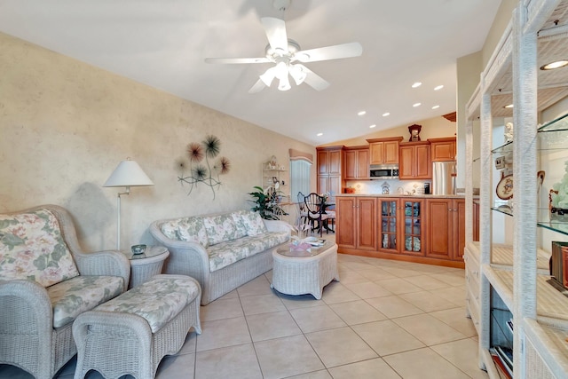 tiled living room featuring vaulted ceiling and ceiling fan