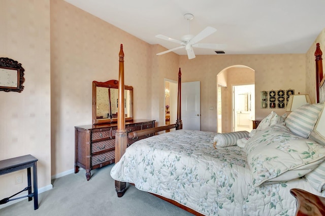 bedroom with light carpet, ceiling fan, and ensuite bathroom