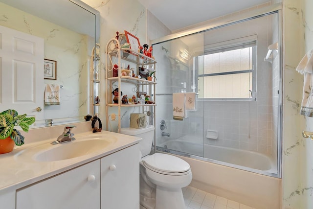 full bathroom with vanity, toilet, tile patterned floors, and bath / shower combo with glass door