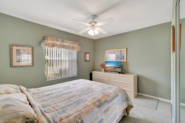 bedroom featuring ceiling fan and light colored carpet