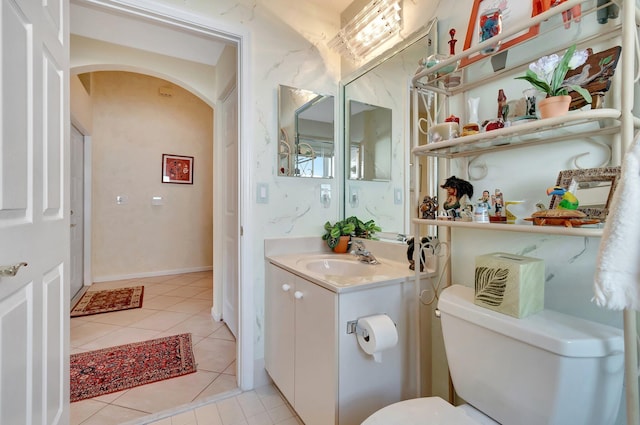 bathroom featuring vanity, tile patterned floors, and toilet