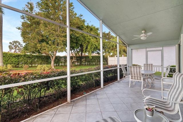 unfurnished sunroom with vaulted ceiling and ceiling fan