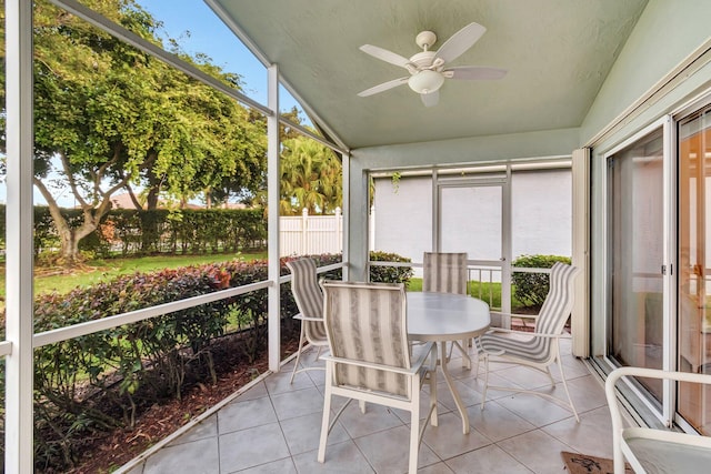 sunroom with ceiling fan and vaulted ceiling