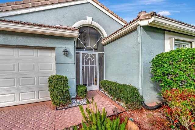 doorway to property with a garage