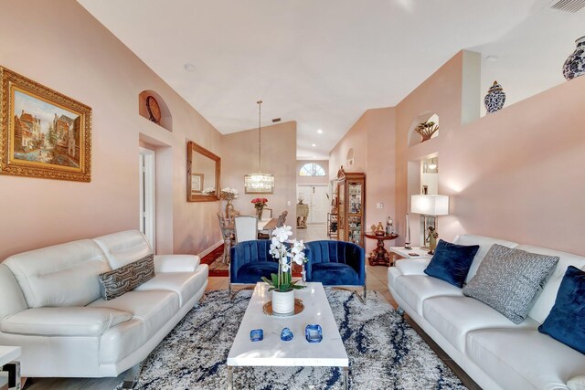 tiled living room featuring ceiling fan and lofted ceiling