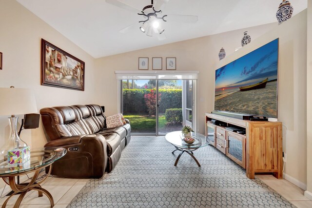 living room with ceiling fan, vaulted ceiling, and light tile patterned floors