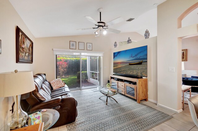 living room with lofted ceiling, light tile patterned floors, and ceiling fan