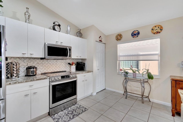 kitchen with white cabinetry, appliances with stainless steel finishes, backsplash, and light stone counters