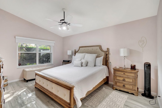 bedroom with vaulted ceiling, ceiling fan, and light hardwood / wood-style floors