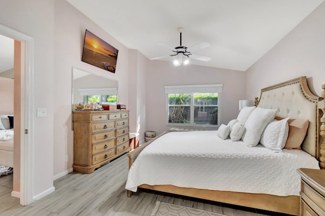 bedroom with vaulted ceiling, ceiling fan, and light hardwood / wood-style floors