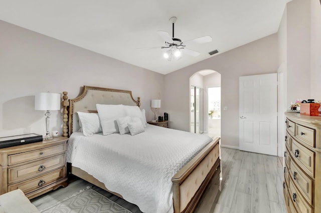 bedroom featuring lofted ceiling, ceiling fan, and light wood-type flooring