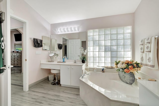 bathroom featuring vanity and a tub