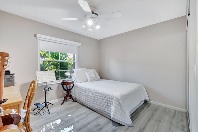 bedroom with ceiling fan and light wood-type flooring