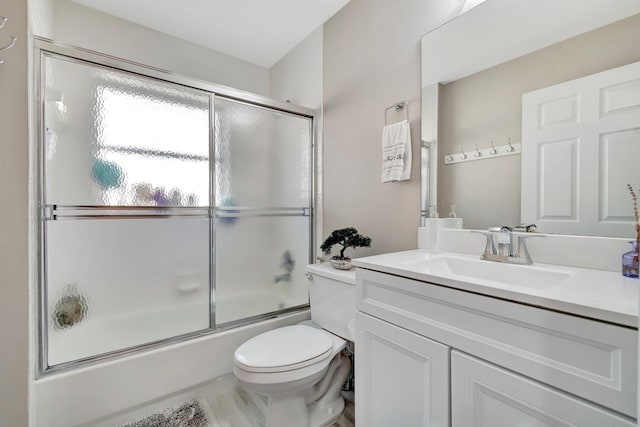 full bathroom with vanity, shower / bath combination with glass door, and toilet