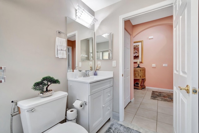 bathroom featuring vanity, tile patterned floors, and toilet