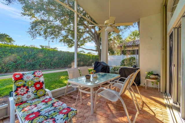 sunroom featuring ceiling fan