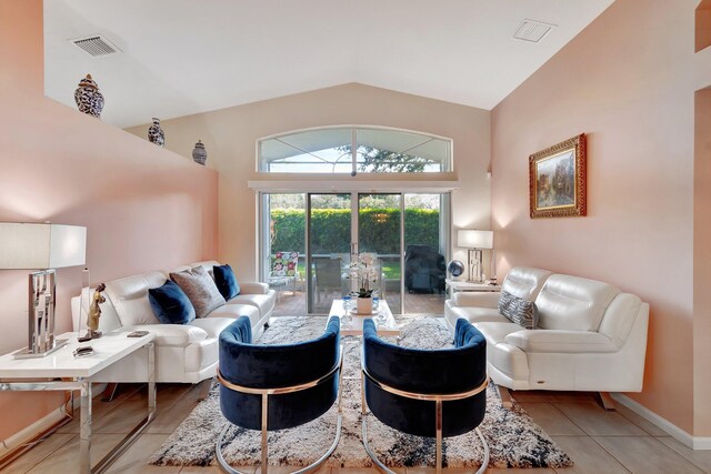 tiled living room with high vaulted ceiling