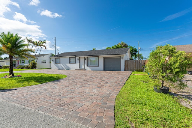 ranch-style home with a garage and a front yard