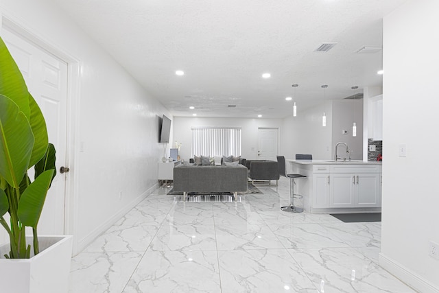 dining area featuring sink and a textured ceiling