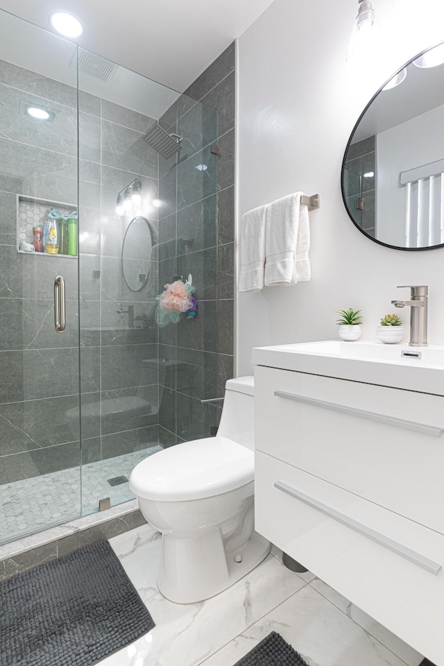 bathroom with walk in shower, vanity, and toilet