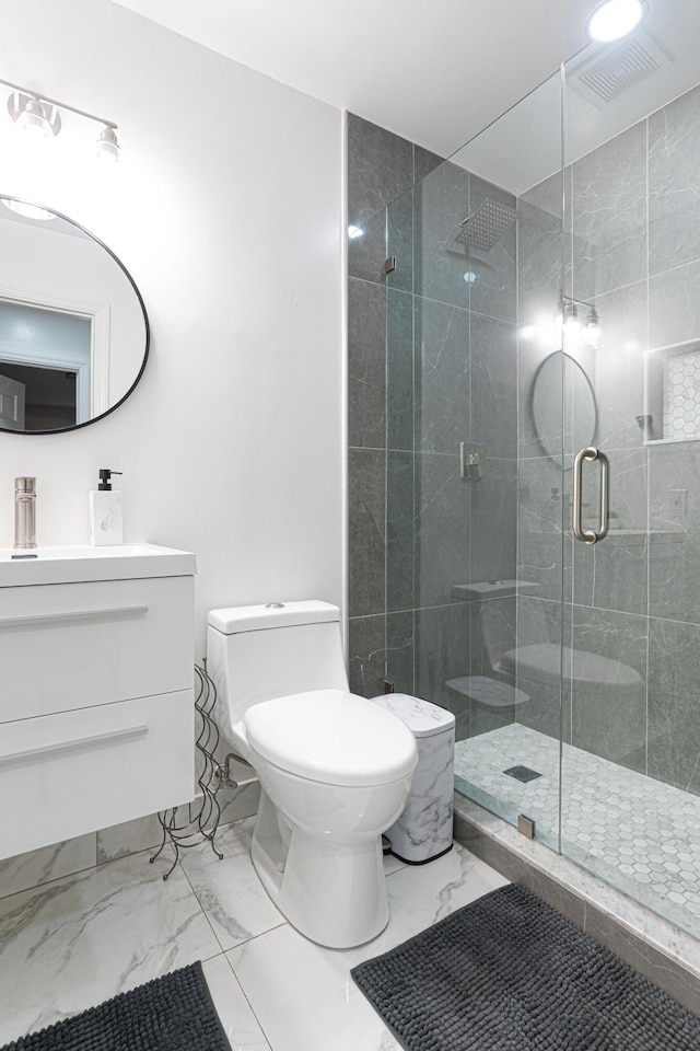 bathroom with vanity, toilet, and an enclosed shower