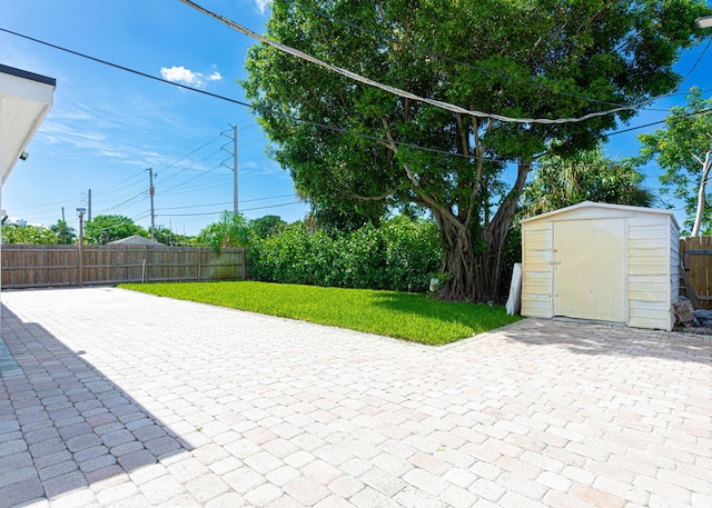 view of patio with a storage shed