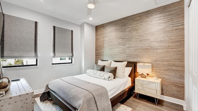 bedroom with wood-type flooring and ceiling fan